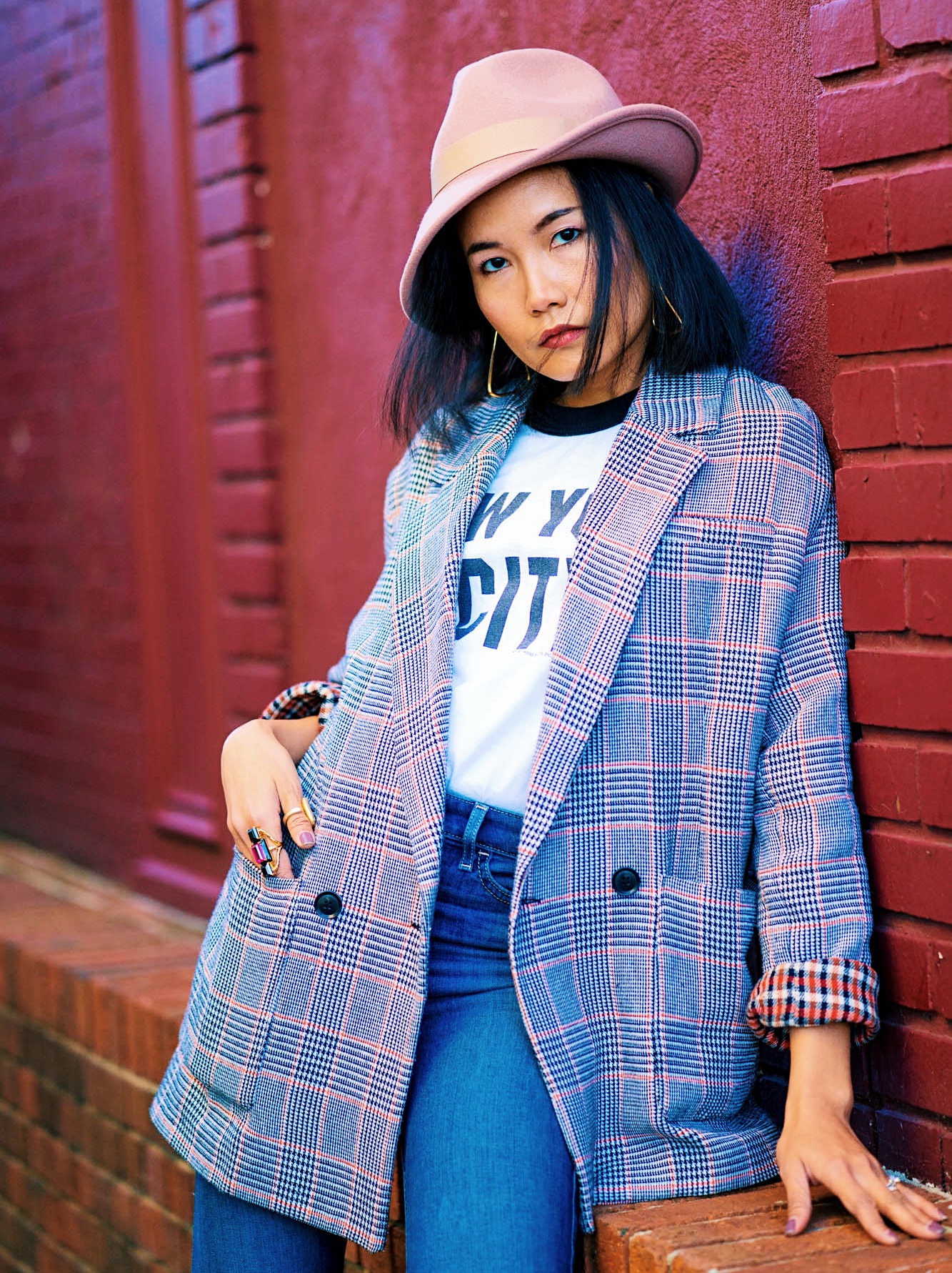 portrait shot wearing I love new york t-shirt blue denim and checked blazer