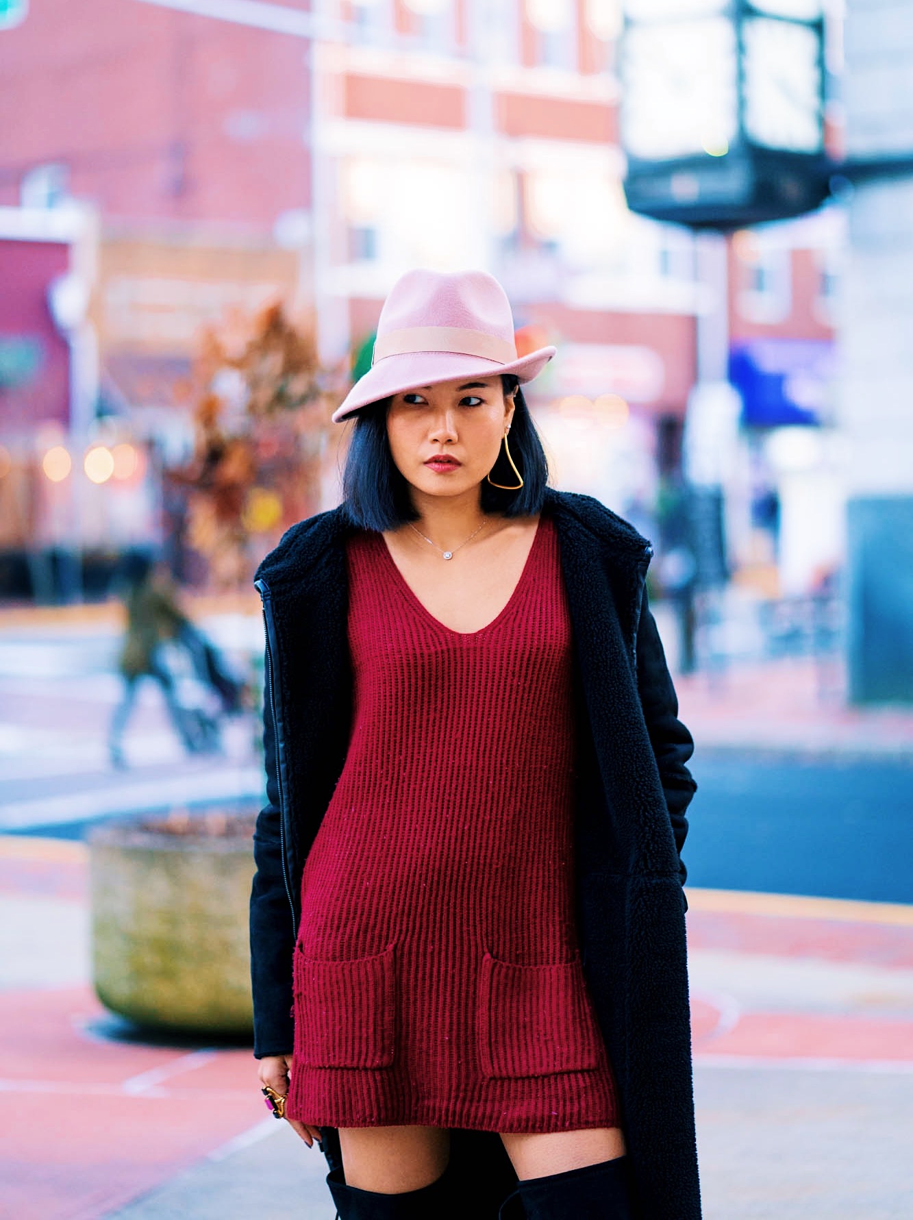 sweater dress with otk boots and a pink fedora hat