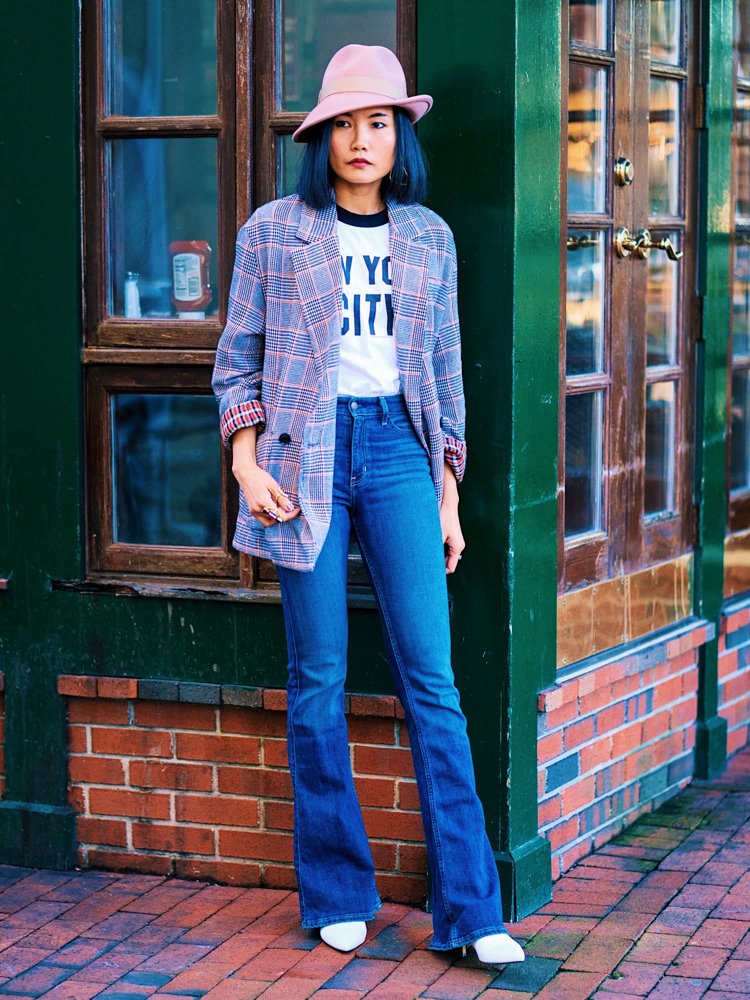 wearing a cool t-shirt with flare jeans checked blazer and an asymmetrical fedora hat for thanksgiving dinner