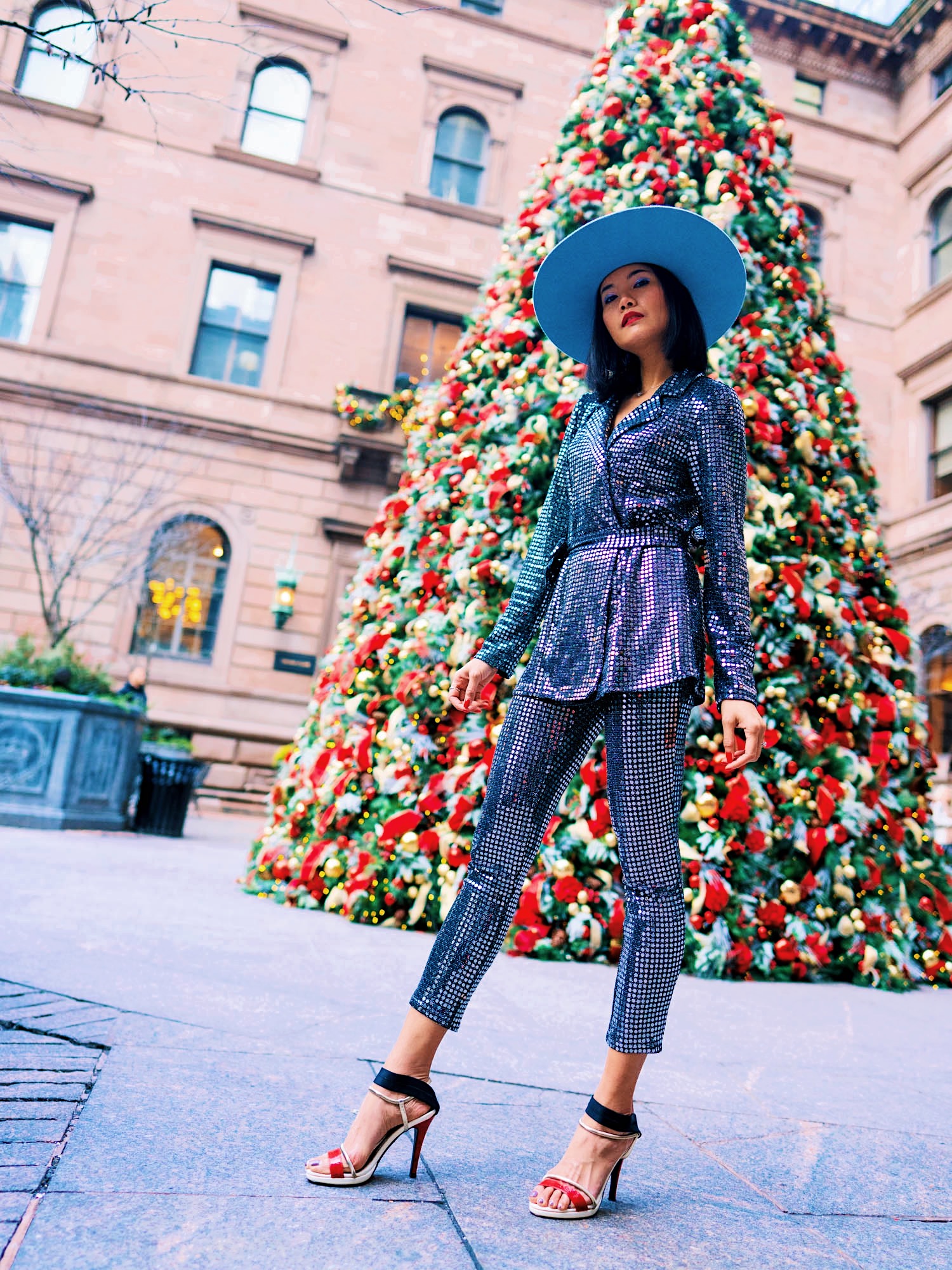 holiday party outfit idea look 1 with a sequin long sleeve suit python sandals and super wide brim hat by vlada