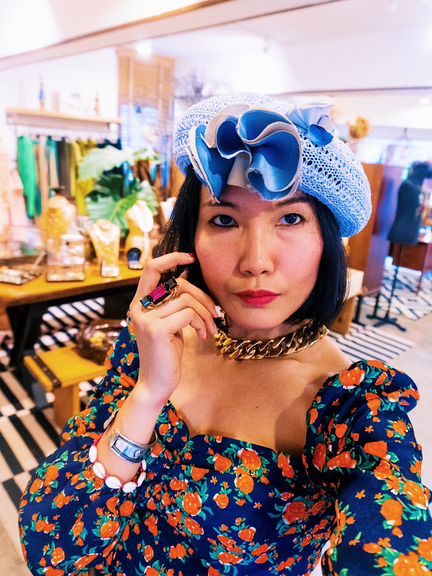 nanphanita is wearing a blue straw beret with flower embellishment made by tete a porter