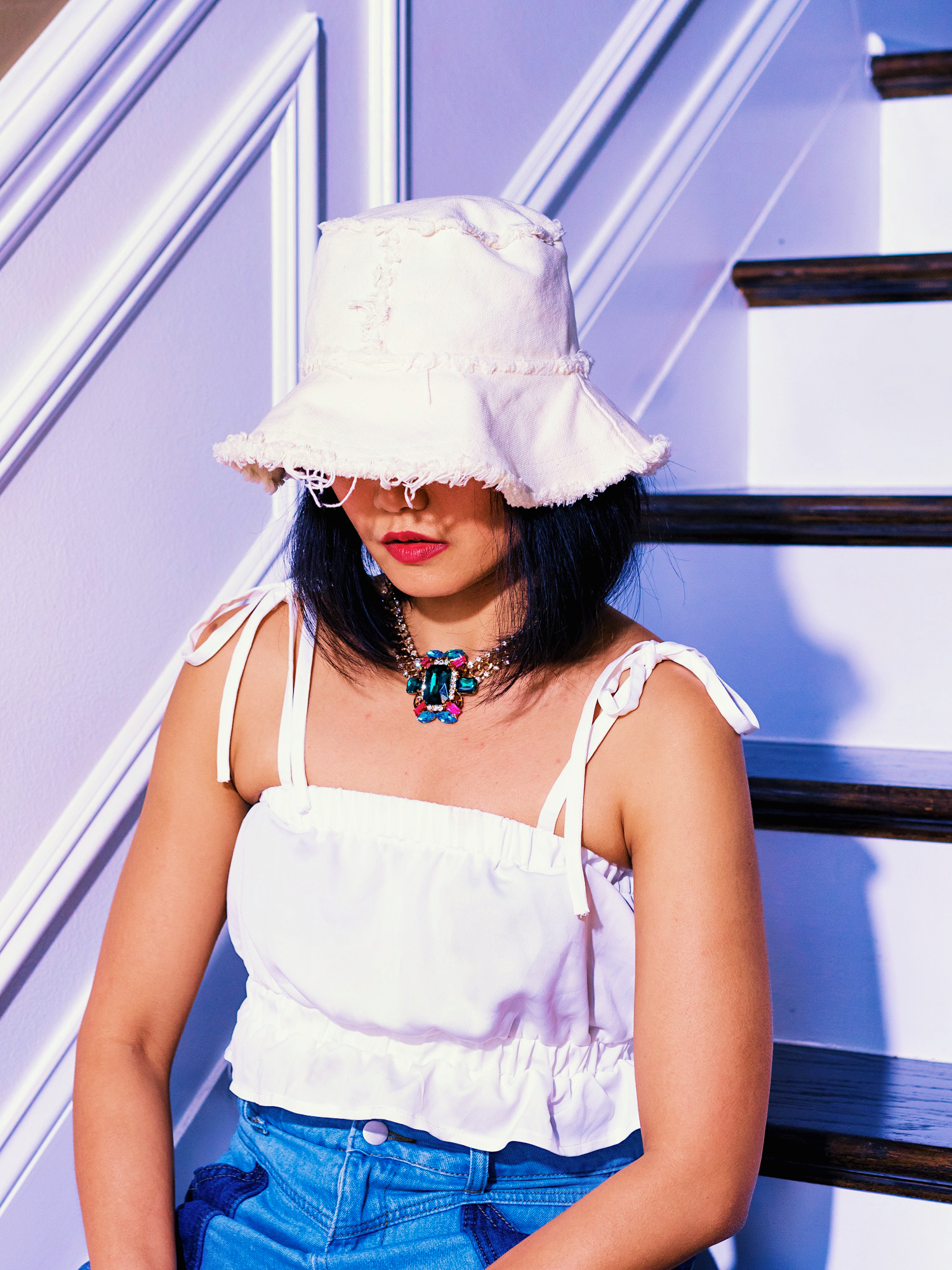 close up nanphanita jacob is wearing jimmy white cotton denim bucket hat by karema deodato millinery