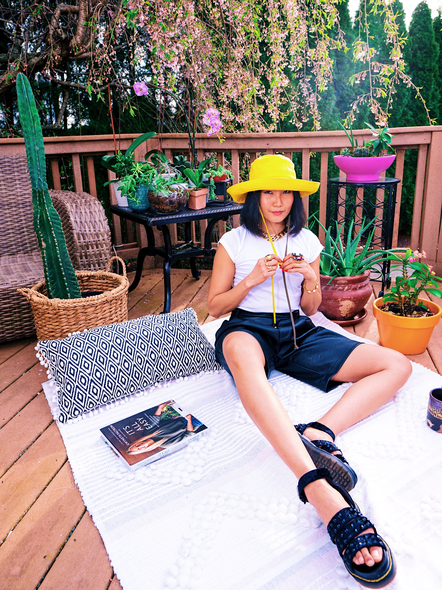 nanphanita jacob is wearing izzy an oversized bright yellow bucket hat made by karema deodato millinery