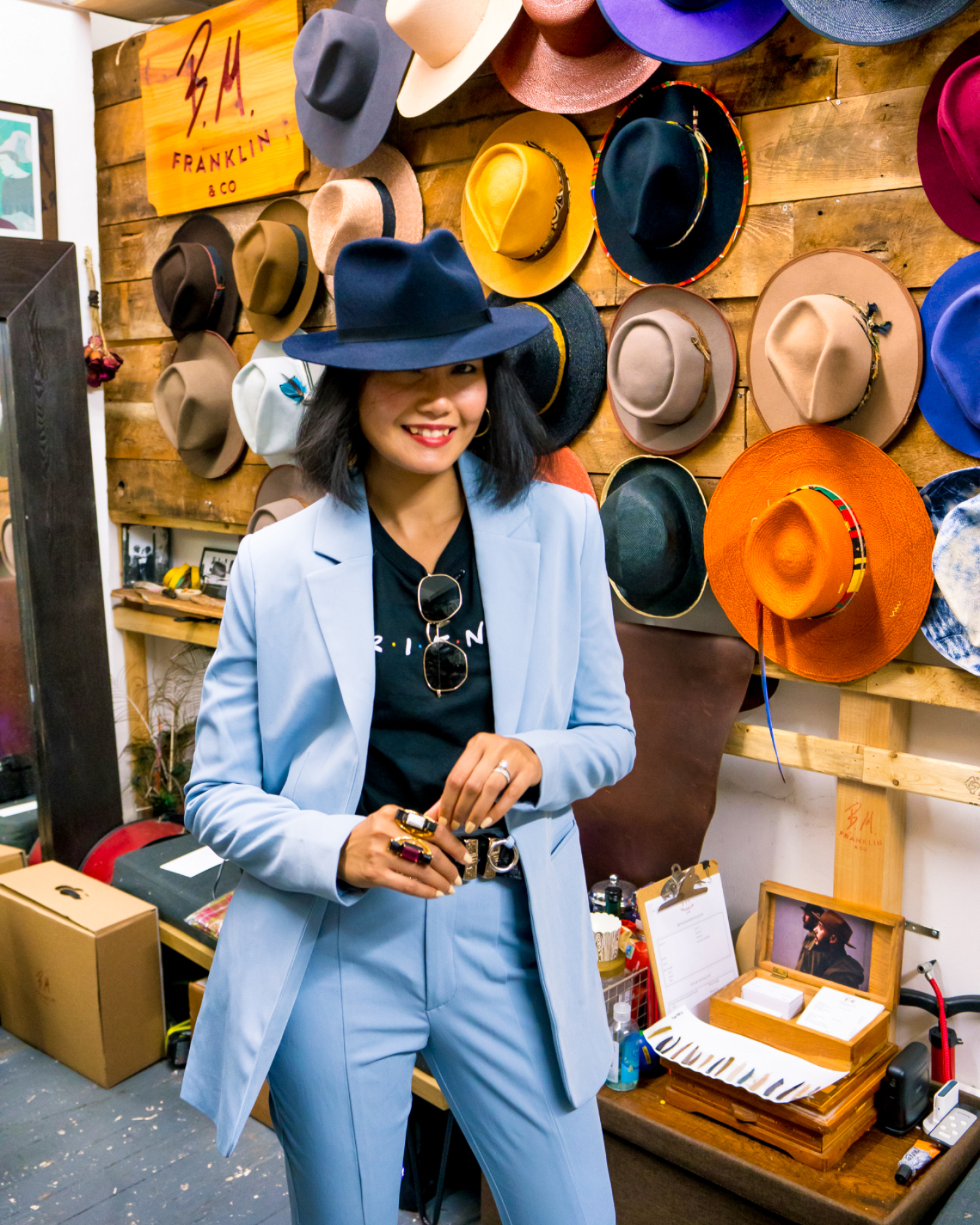 nanphanita visits bm franklin co in nyc and tries on unique hats