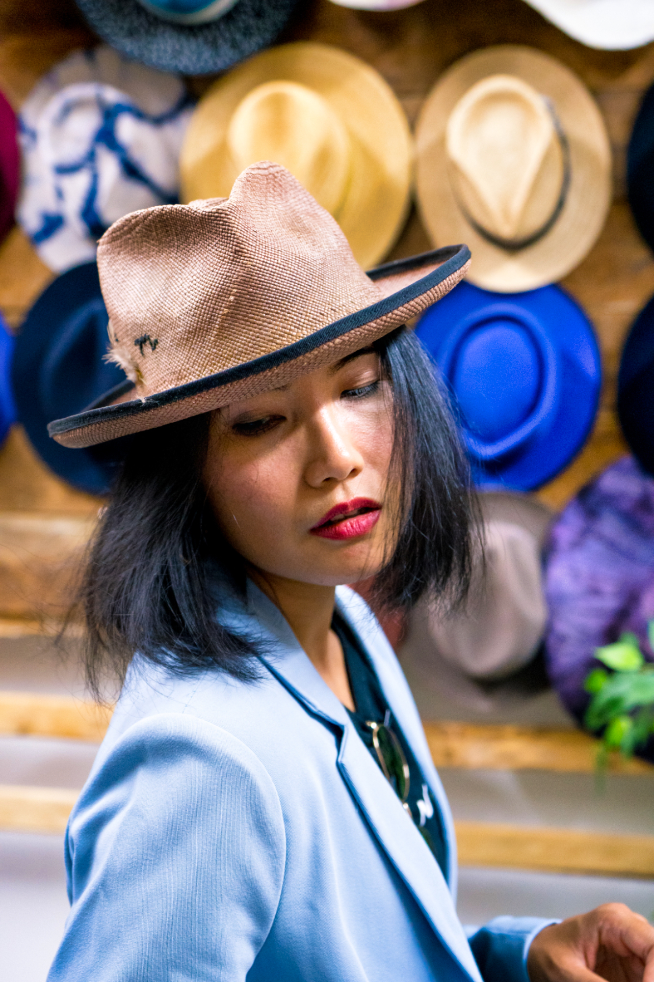 nanphanita tries one of a kind straw hat in tan color at bm franklin co nyc