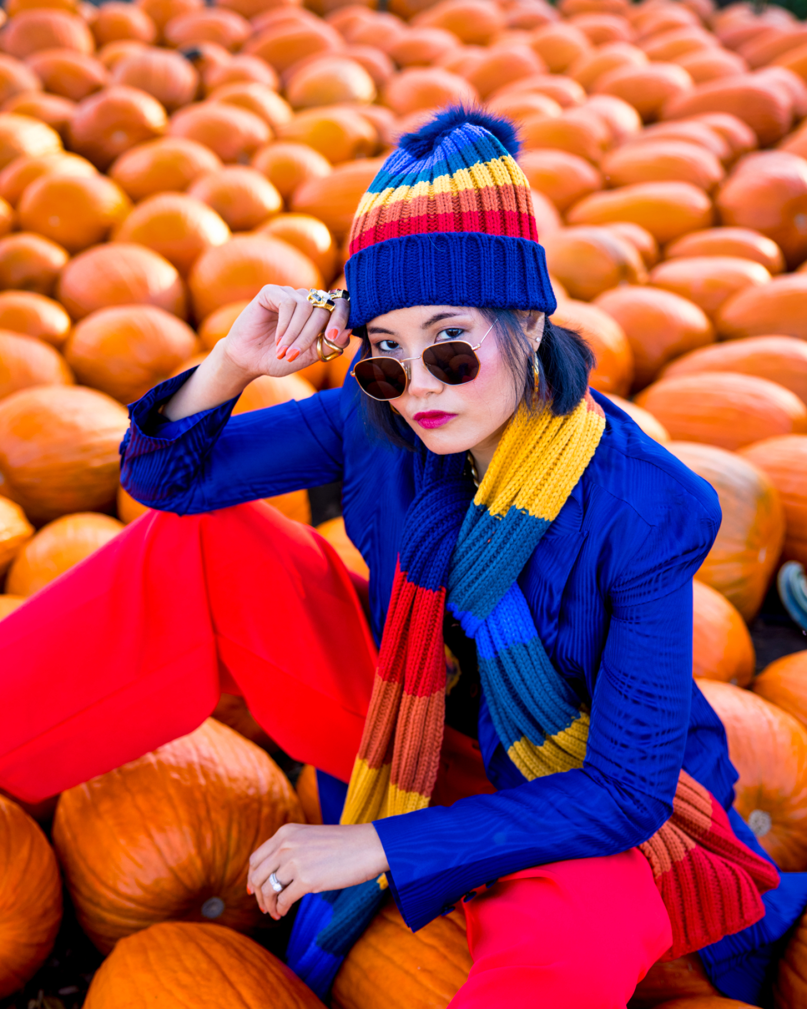 cold weather outfit fashion by nanphanita jacob is wearing san diego hat company rainbow stripe beanie and scarf set in colorful outfit in new jersey fashion