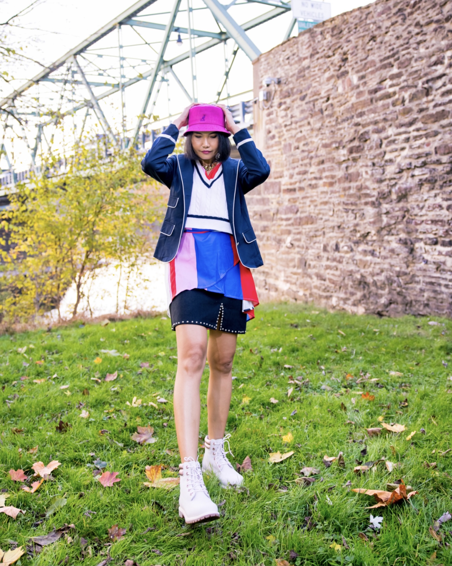 emily in paris outfit inspired for less by nanphanita jacob is wearing colorful layered outfit and kangal pink bucket hat
