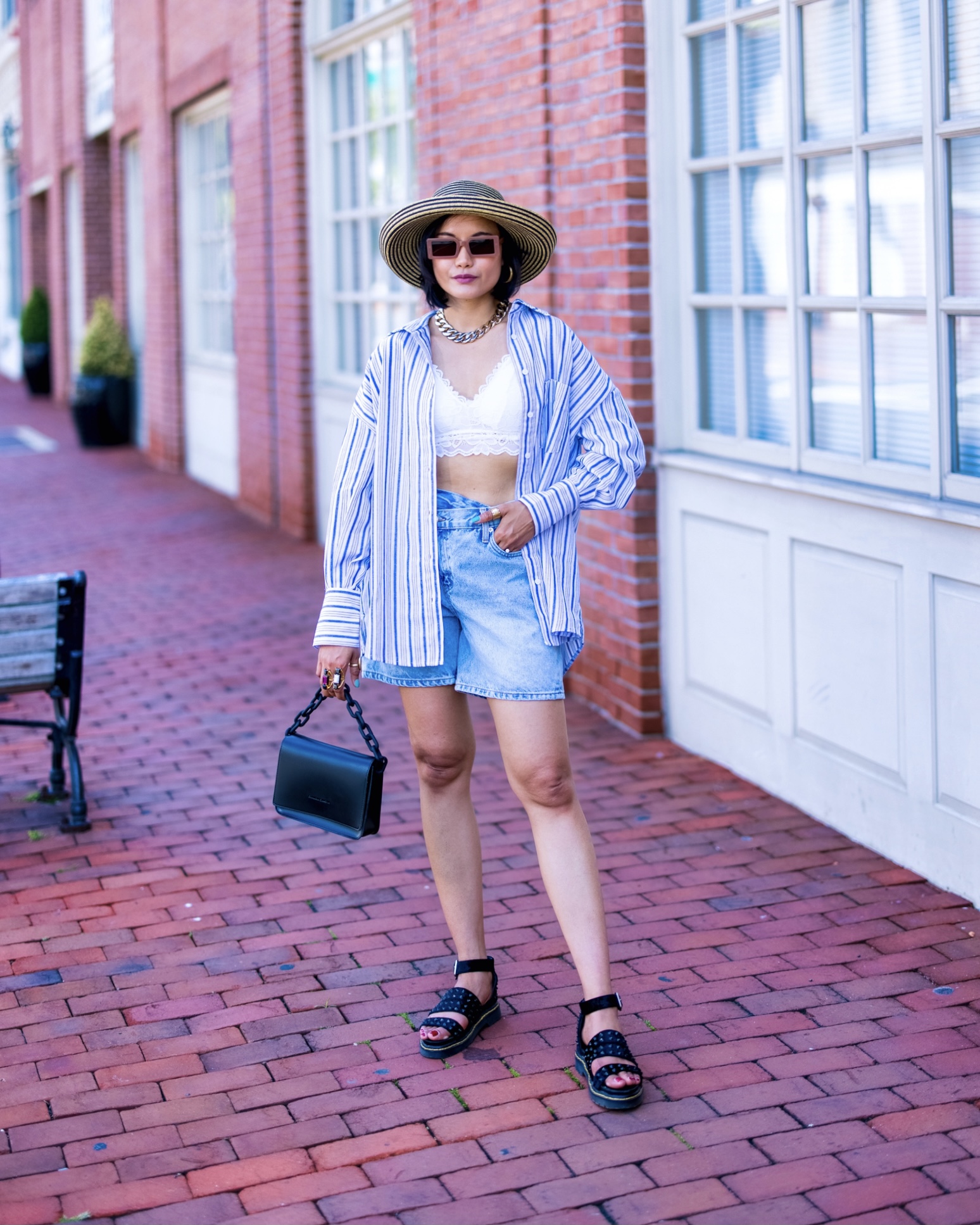 nanphanita jacob is rocking streetwear with a lace barrette pairing with criss cross short denims and top off with an oversized stripe shirt