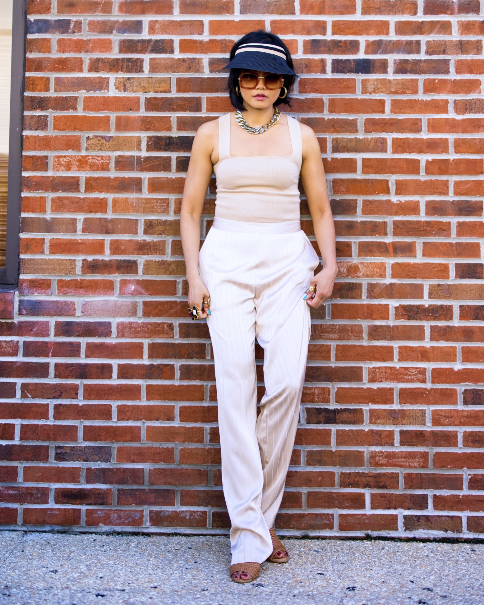 nanphanita jacob is styling neutral look with trending black visor hat by san diego hat company